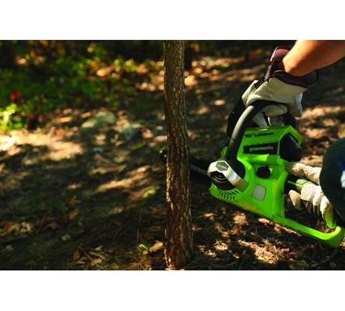 Side view of Greenworks G24CSK2 24V Chainsaw c/w battery and charger